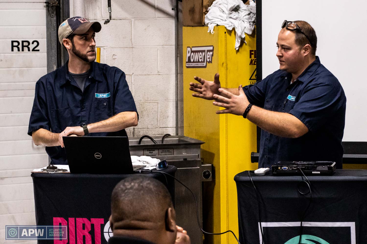 Wags and Lee teaching pressure washing maintenance