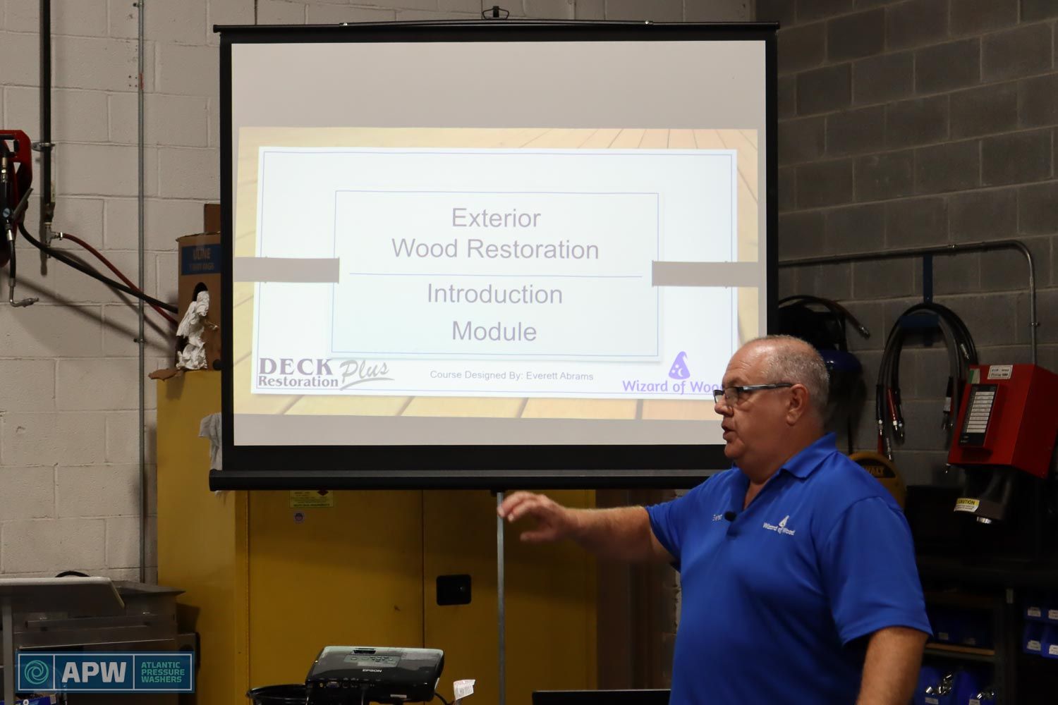 Everett Abrams standing in front of info slide from Wood Restoration seminar