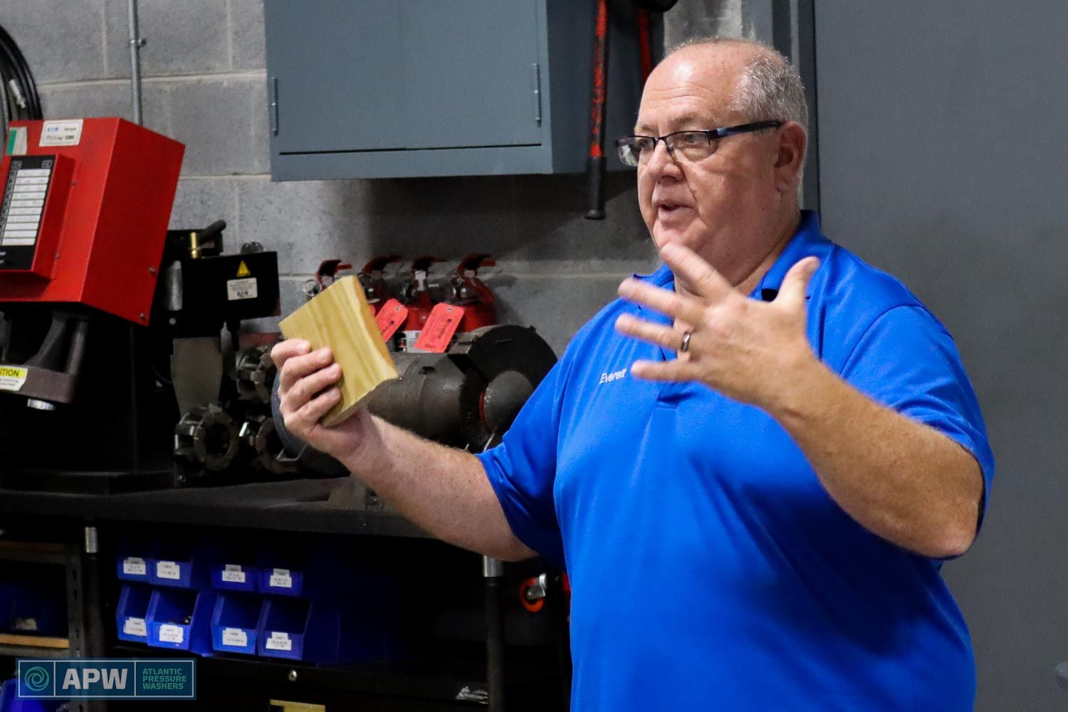 Everett Abrams holding a piece of wood and discussing wood restoration